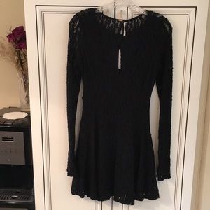 Black lace mini dress. Form fitting with spandex. Extra long sleeves.